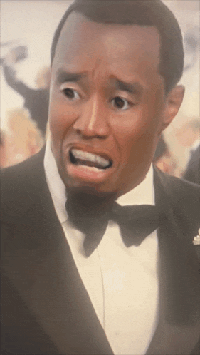 a man in a tuxedo with his mouth open