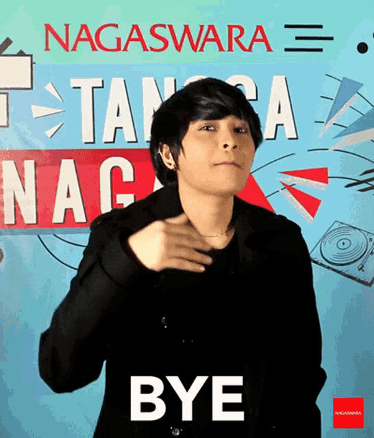 a man in front of a sign that says nagaswara on it