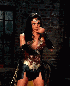 a woman in a wonder woman costume is holding a sword