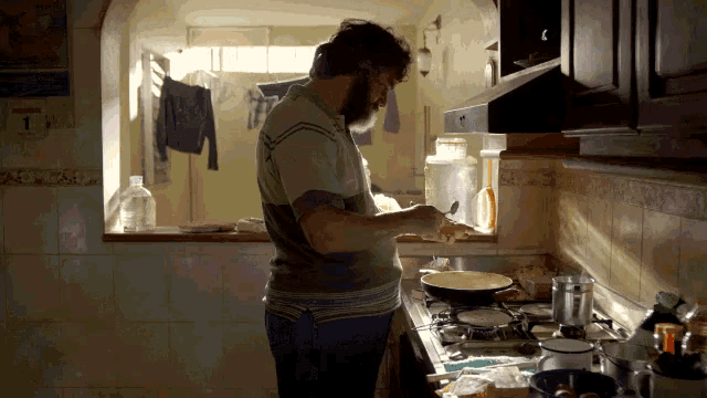 a man prepares food in a kitchen with a calendar hanging on the wall that shows the date as january 1