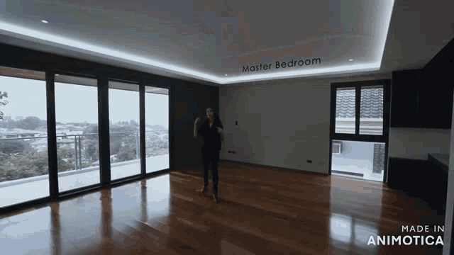 a woman is standing in an empty room with the words master bedroom written on the ceiling