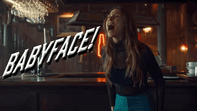 a woman is screaming in a bar and the words babyface are behind her