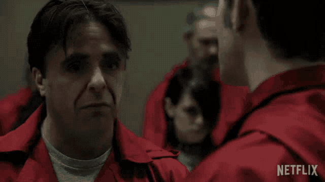 a man in a red jumpsuit is talking to another man in a netflix advertisement