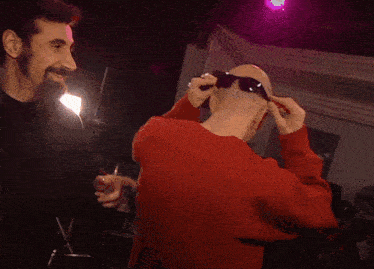 a bald man wearing sunglasses is being punched
