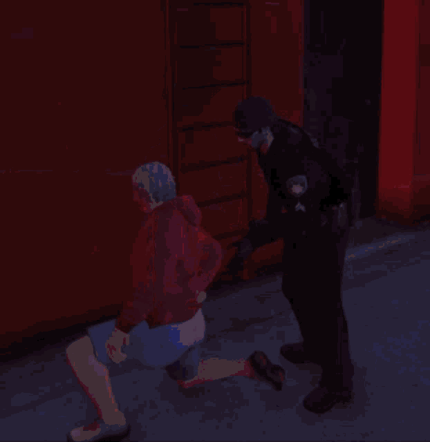 a person in a red hoodie is climbing a ladder in a dark room