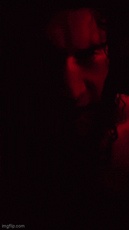 a close up of a person 's face in a red light