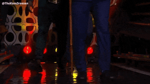 two men in suits are walking on a stage with a cane ..