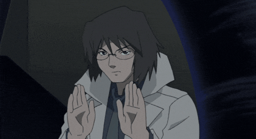 a man with glasses and a white coat is making a stop sign with his hands