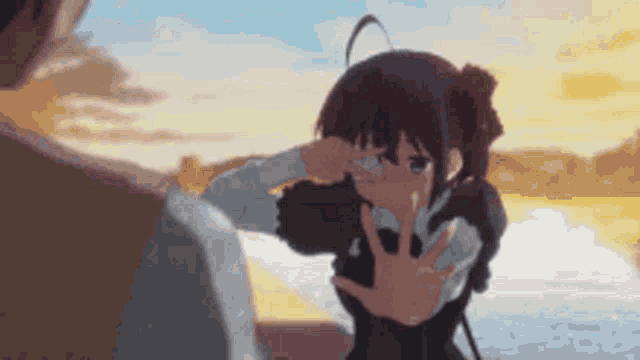 a girl is crying and covering her face with her hand while a man looks on .