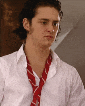 a man wearing a white shirt and a red striped tie