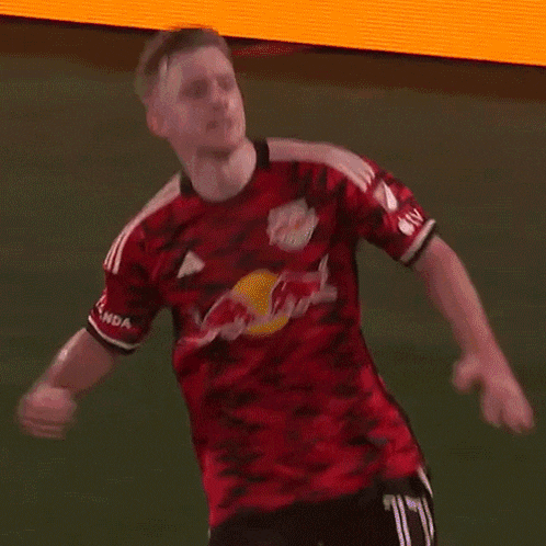 a man in a red jersey with the word red bull on it