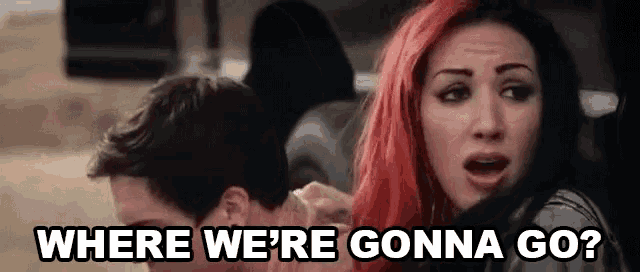 a woman with red hair is sitting in the back seat of a car with a man .