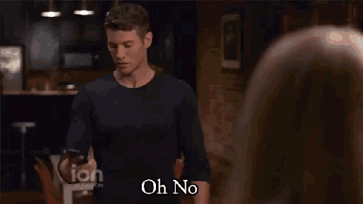 a woman in a plaid shirt says oh yeah in front of a brick wall
