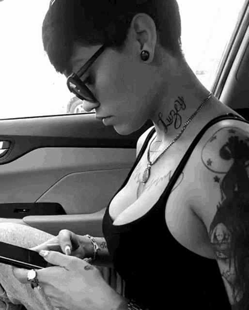 a woman with a tattoo on her neck has the name luzy on it