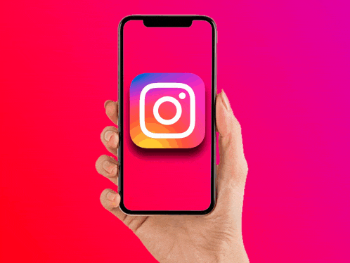 a hand is holding a cell phone with an instagram icon on it