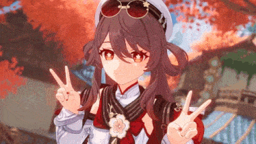 the girl is wearing a hat and sunglasses and making a peace sign .