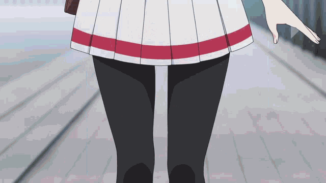 a girl in a white skirt with a red stripe on the waist