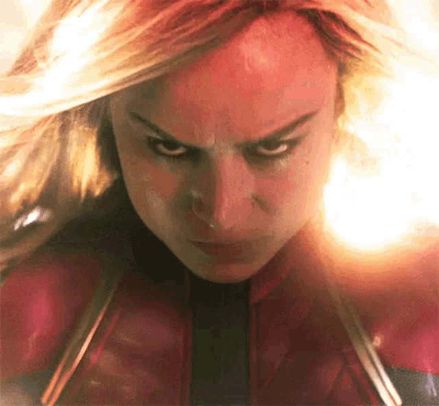a close up of a woman 's face in a superhero costume with a serious look on her face .
