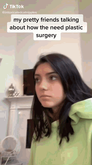 a girl in a green shirt is talking about plastic surgery