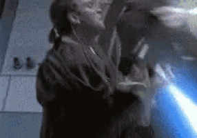 a man is holding a light saber in his hand while another man holds a light saber in his hand .