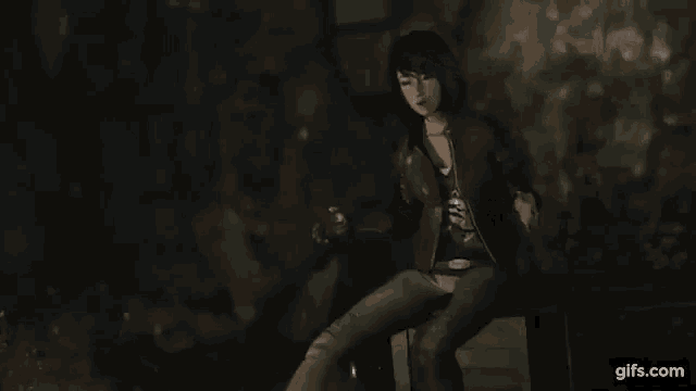 a woman is sitting on a box in a dark room holding a bottle of beer .