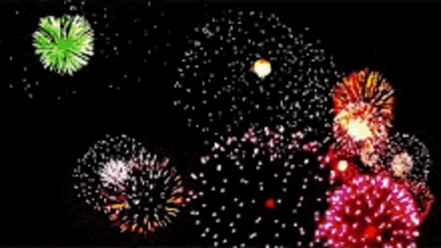 a bunch of colorful fireworks are exploding in the night sky