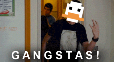 a man in a black shirt is standing in front of a door that says gangstas on it
