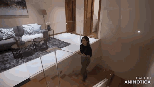 a woman is walking down a set of stairs in a living room made by animatica