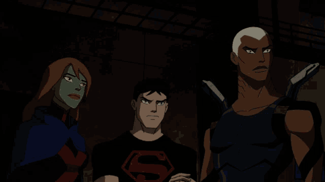 a man in a superman shirt stands next to a woman