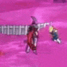 a blurry picture of a person holding a sword on a pink background .