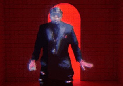 a blurry picture of a man in a suit standing in a red doorway