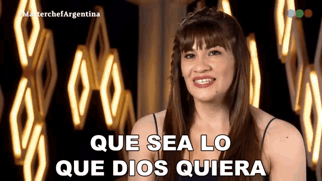 a woman says que sea lo que dios quiera in front of lights