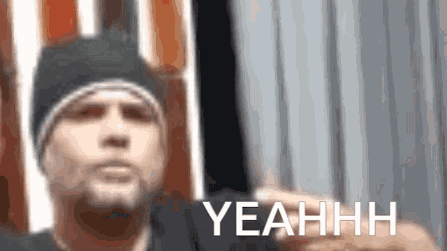 a blurry picture of a man with the word yeahhh on the bottom right