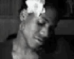 a black and white photo of a man with smoke coming out of his head .