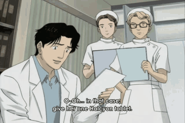 a man in a lab coat is talking to two nurses who are holding clipboards