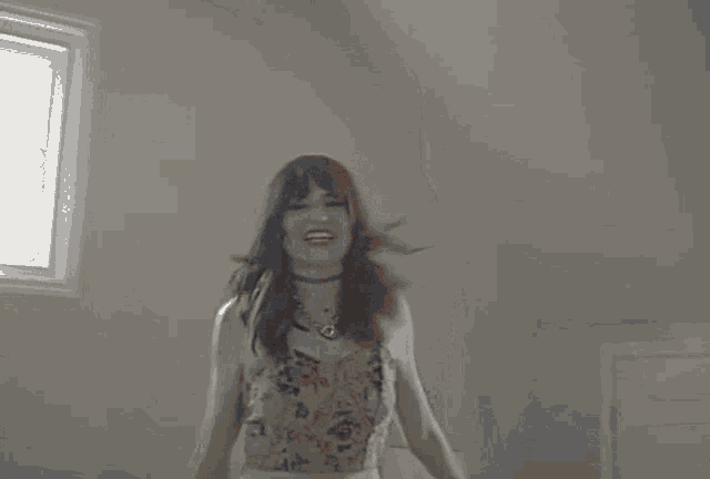 a blurry picture of two women laying on a bed with their arms outstretched