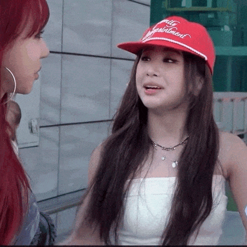 a woman with red hair wearing a red hat that says " all equipment "