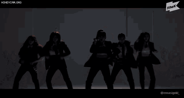 a group of women in suits and ties are dancing in a row
