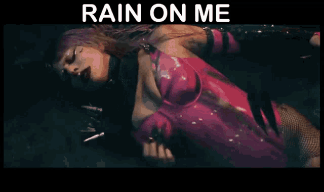 a woman in a pink bodysuit is laying on the ground with the words rain on me above her