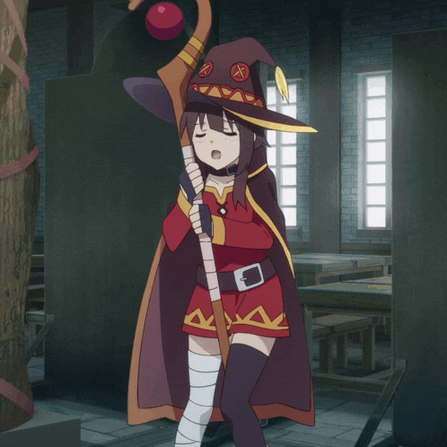 a girl in a witch costume holds a cane
