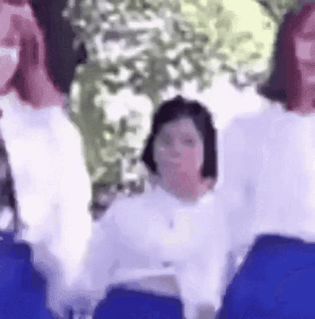 a group of people are standing next to each other in a park .