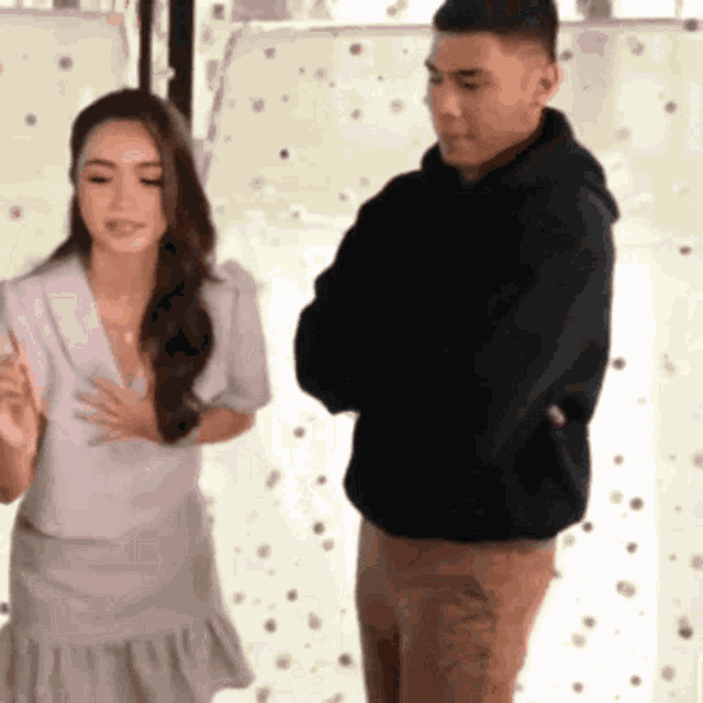 a man and a woman are standing next to each other