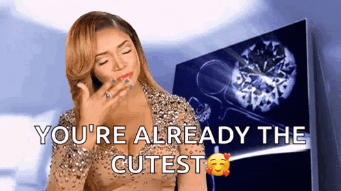 a woman in a sequined dress says " you 're already the cutest " in front of a diamond