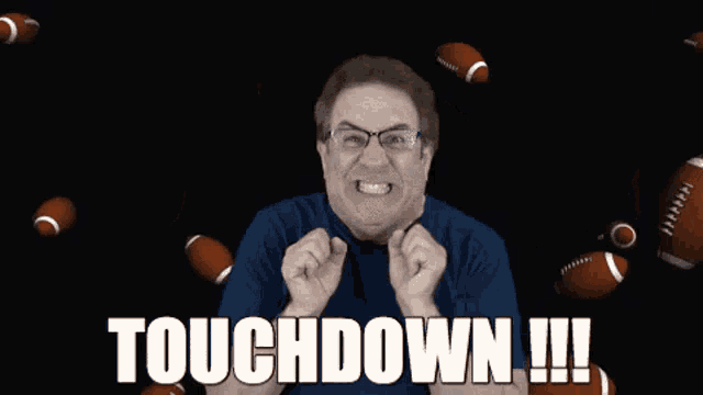 a man with glasses and a blue shirt is celebrating a touchdown