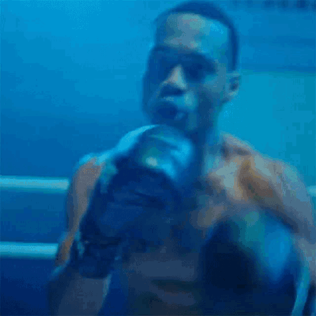 a man is wearing boxing gloves in a ring .