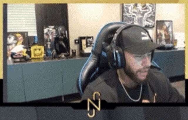 a man wearing headphones and a hat with the letter n on his chest