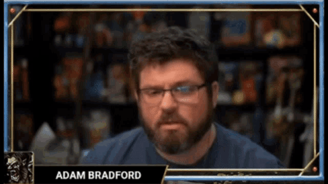 a man with glasses and the name adam bradford on the bottom