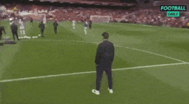 a man stands on a soccer field next to the name jurgen klopp