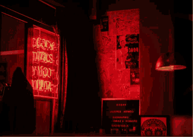 a neon sign that says bad habits is lit up in red