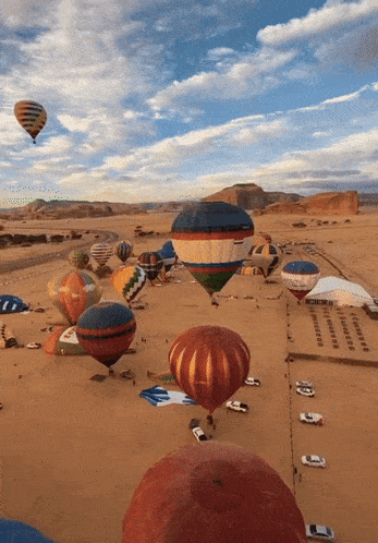 a bunch of hot air balloons are flying over the desert